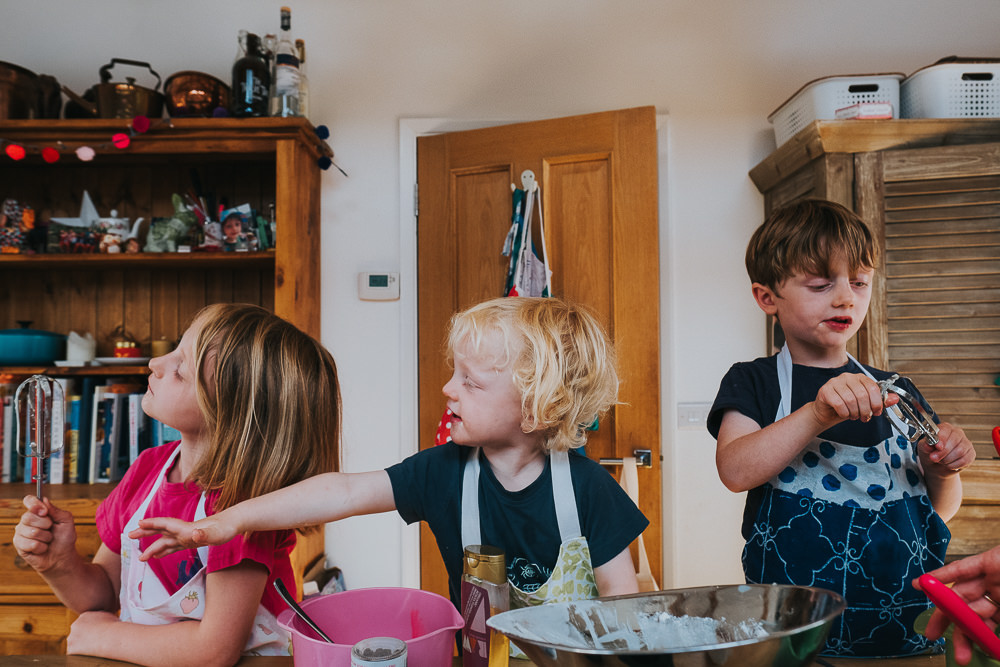 day in the life photographer children baking and licking cake mix from beaters