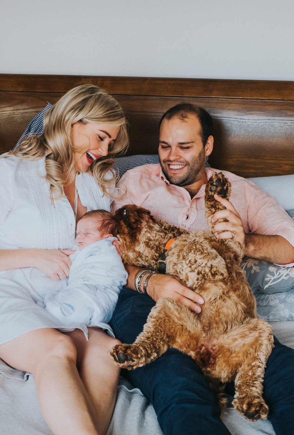 COCKAPOO AND NEWBORN BABY PHOTO SHOOT ON BED FULHAM NEWBORN PHOTOGRAPHER