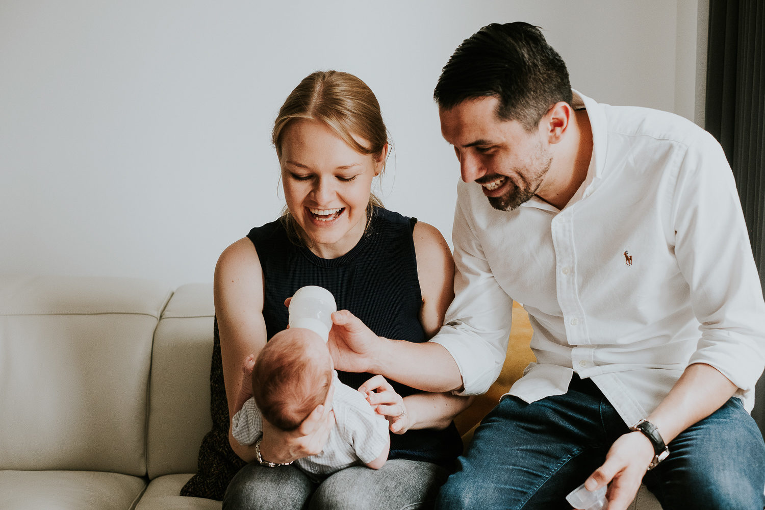 LONDON NEWBORN PHOTOS LIFESTYLE NATURAL LIGHT PORTRAIT OF BABY WITH PARENTS FEEDING