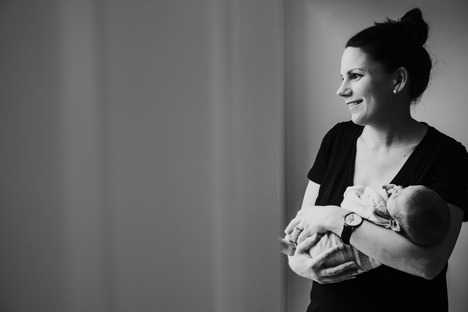 mother holding baby son black and white photo london newborn photography