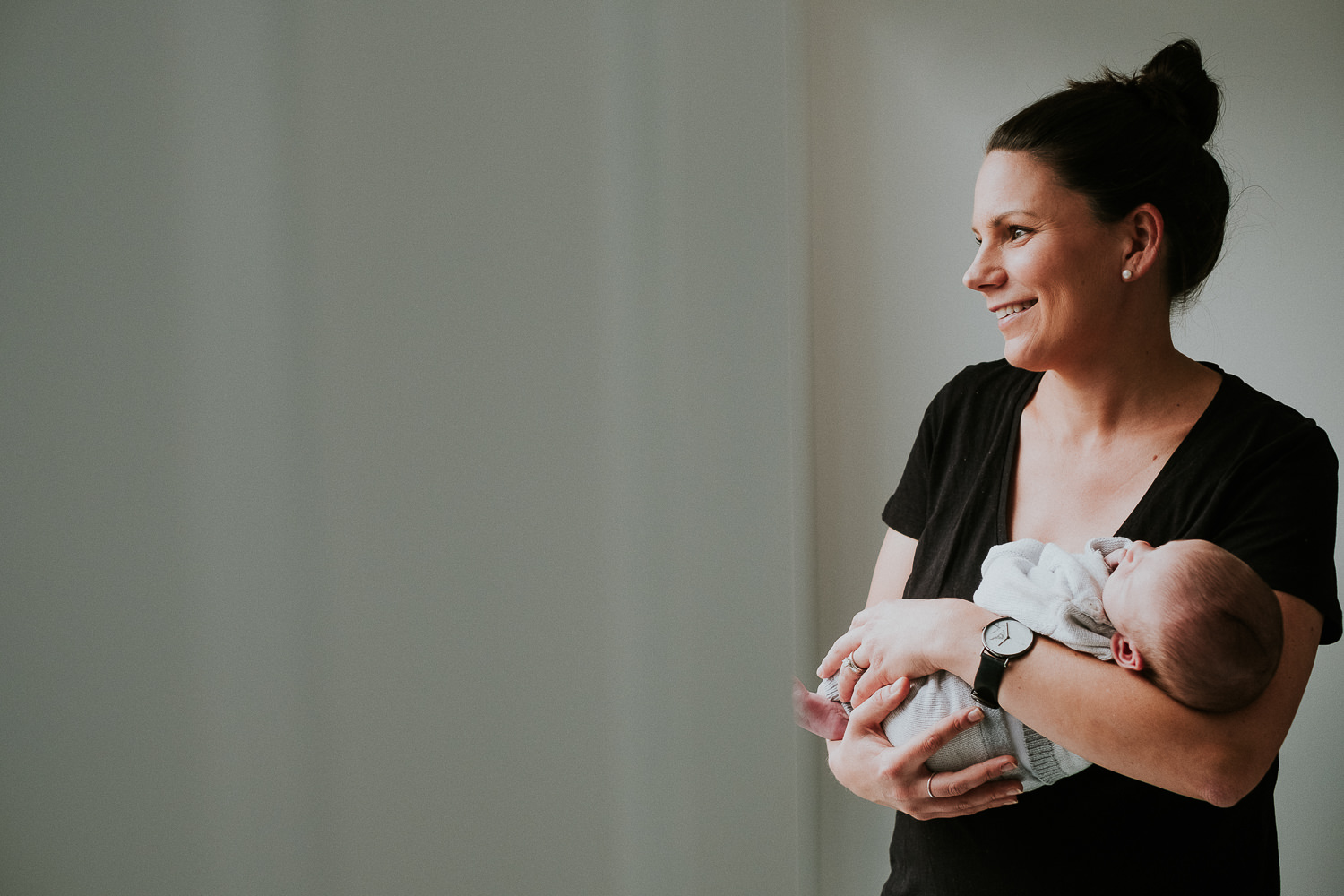 mother holding baby son london newborn photography