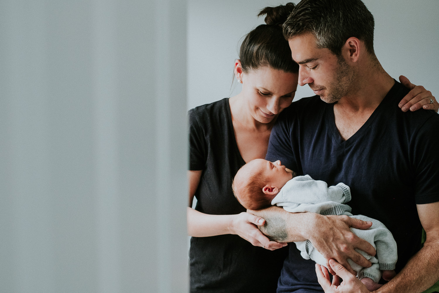 new parents holding baby son london newborn photography