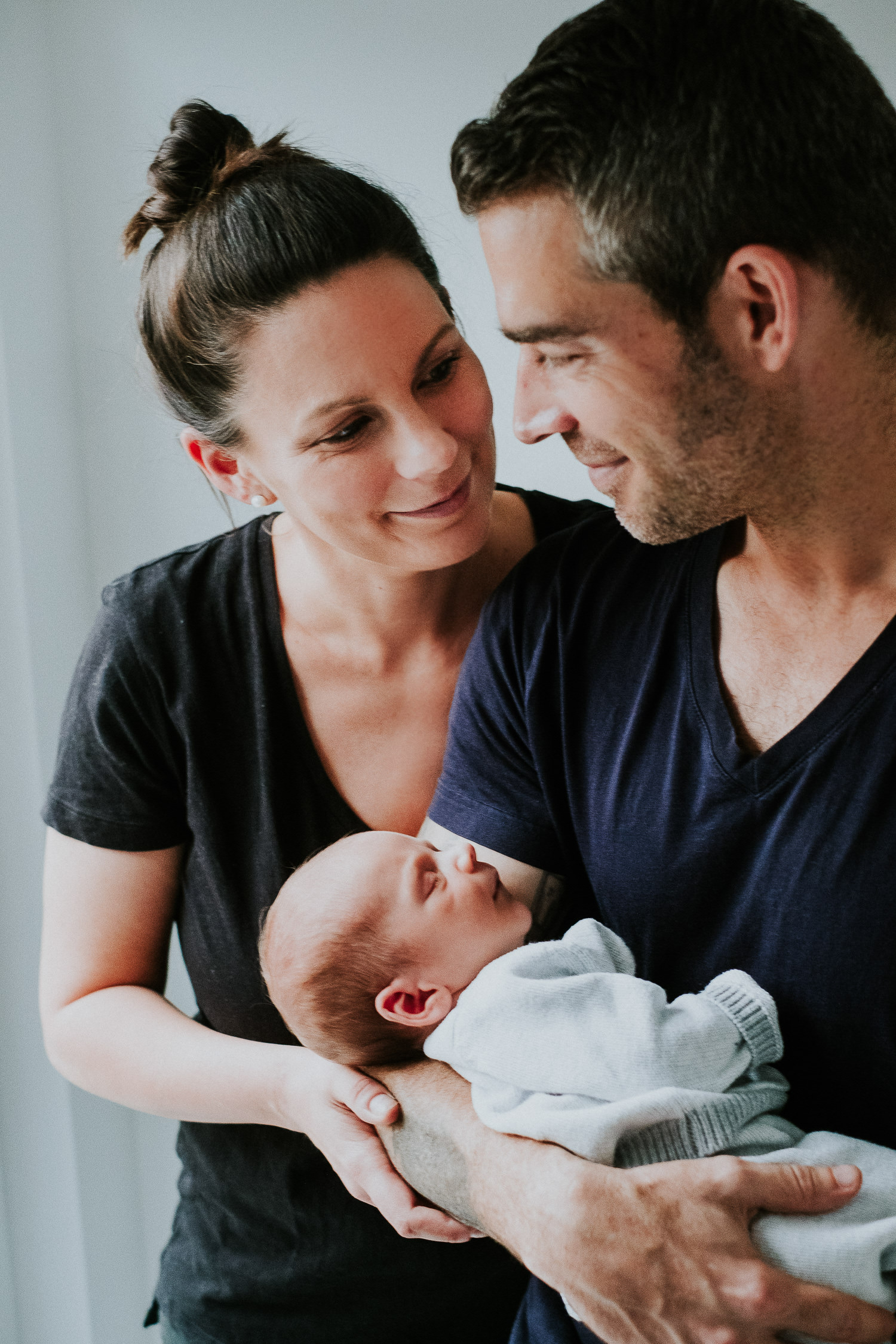 new parents holding baby son london newborn photography