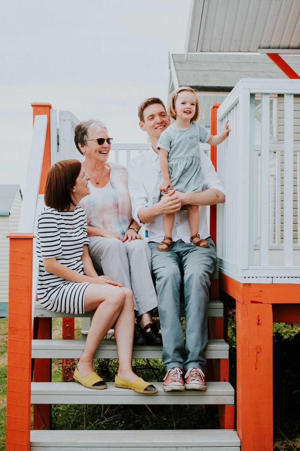 FAMILY SITTING ON BEACH HUT STEPS WHITSTABLE FAMILY PHOTOGRAPHER