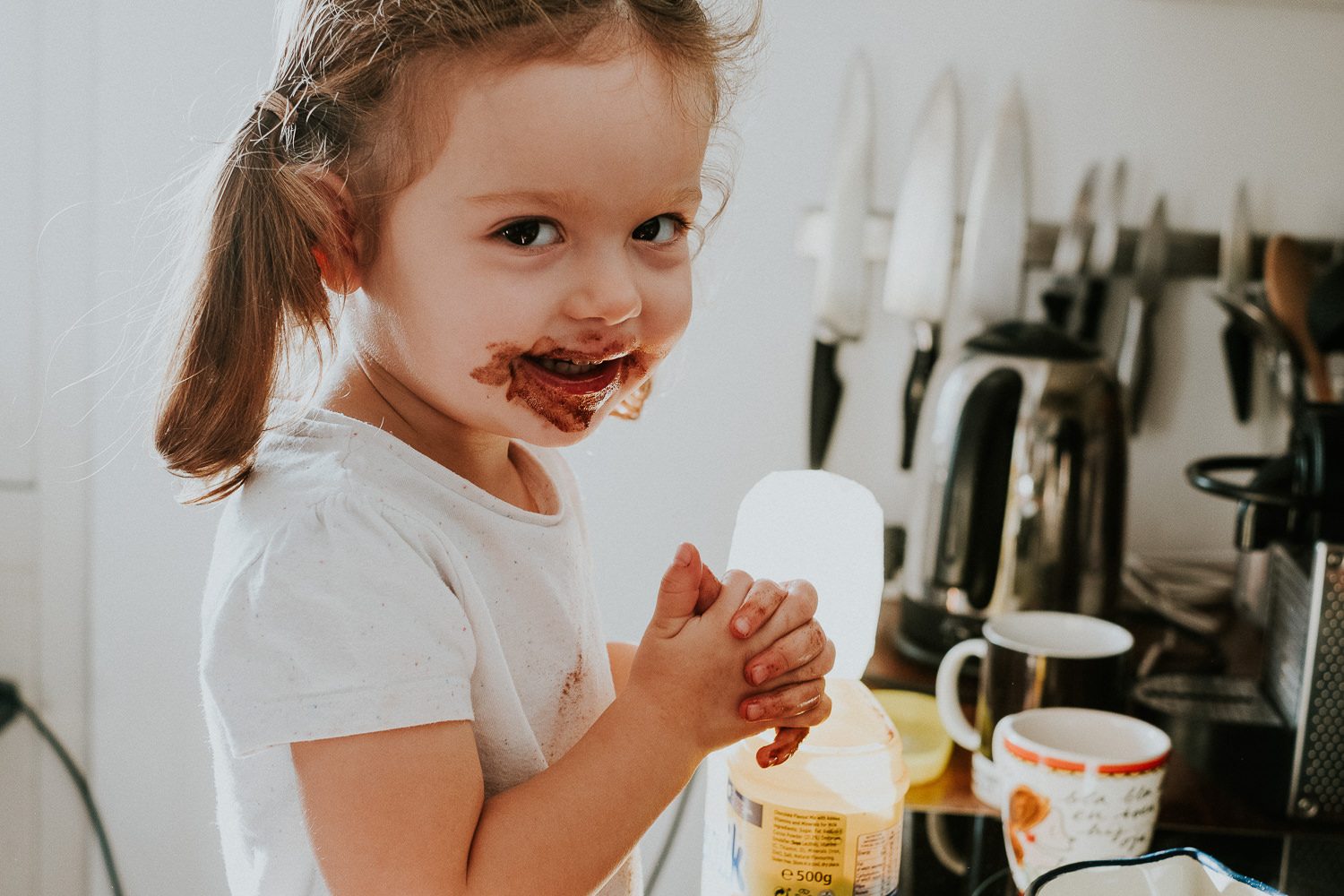 5 reasons you shouldn't wear matching outfits for your family photos. Toddler with chocolate face.