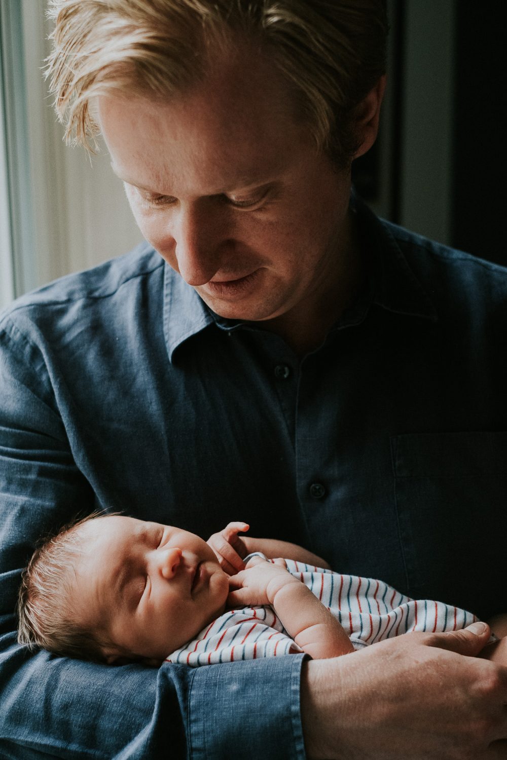 South Kensington Newborn Photographer. Father with baby girl in arms.