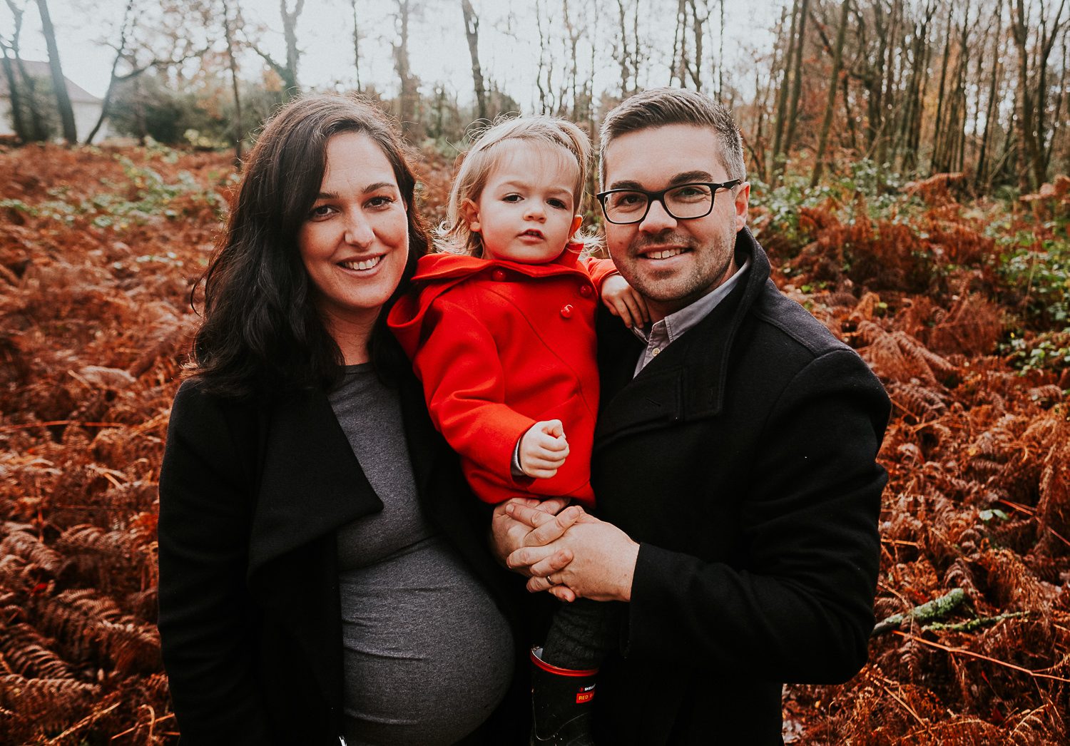 Surrey maternity photographer parents and toddler in woods