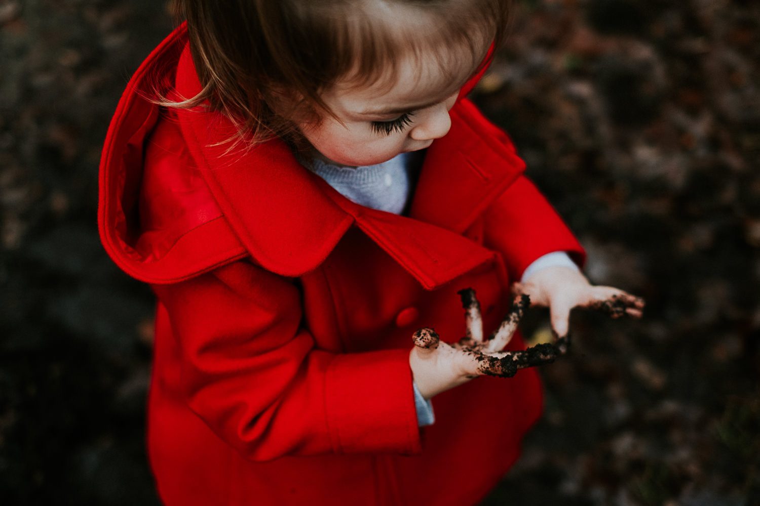 SurrGirl toddler playing in mud