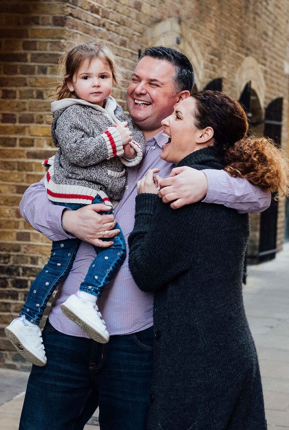 Parents with toddler daughter laughing