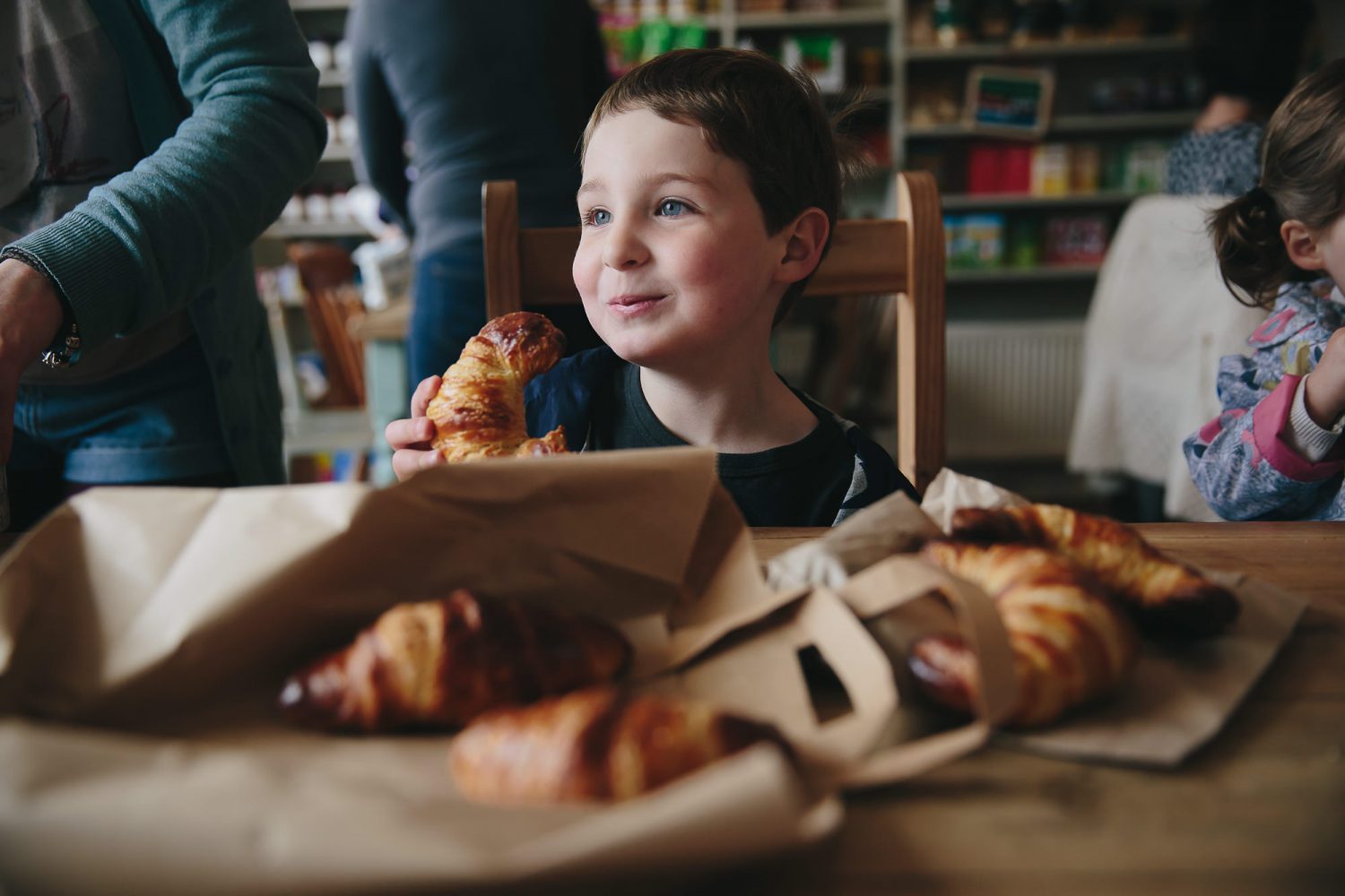 Young boy enjoying pastry at cafe 