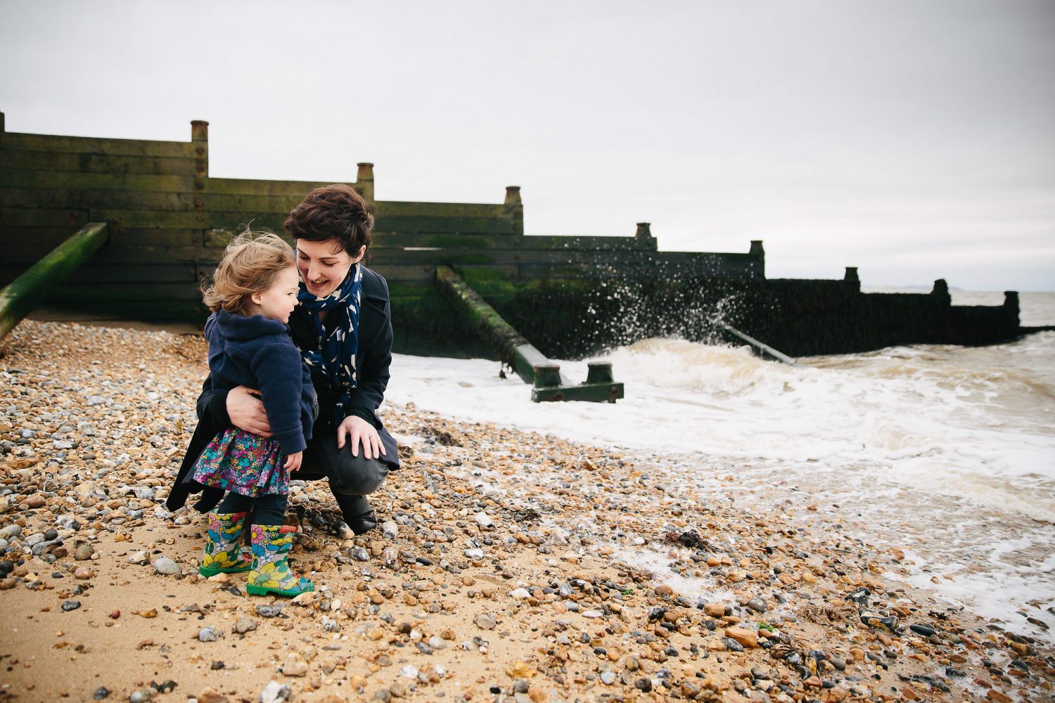 Mum with toddler daughter on beach in Whistable