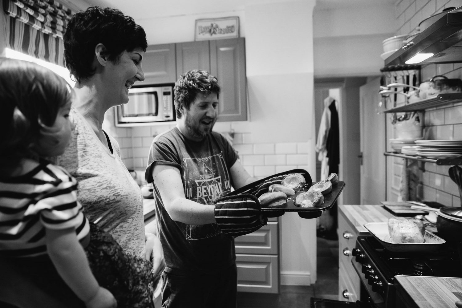 day in the life photography mum and dad in kitchen cooking black and white image