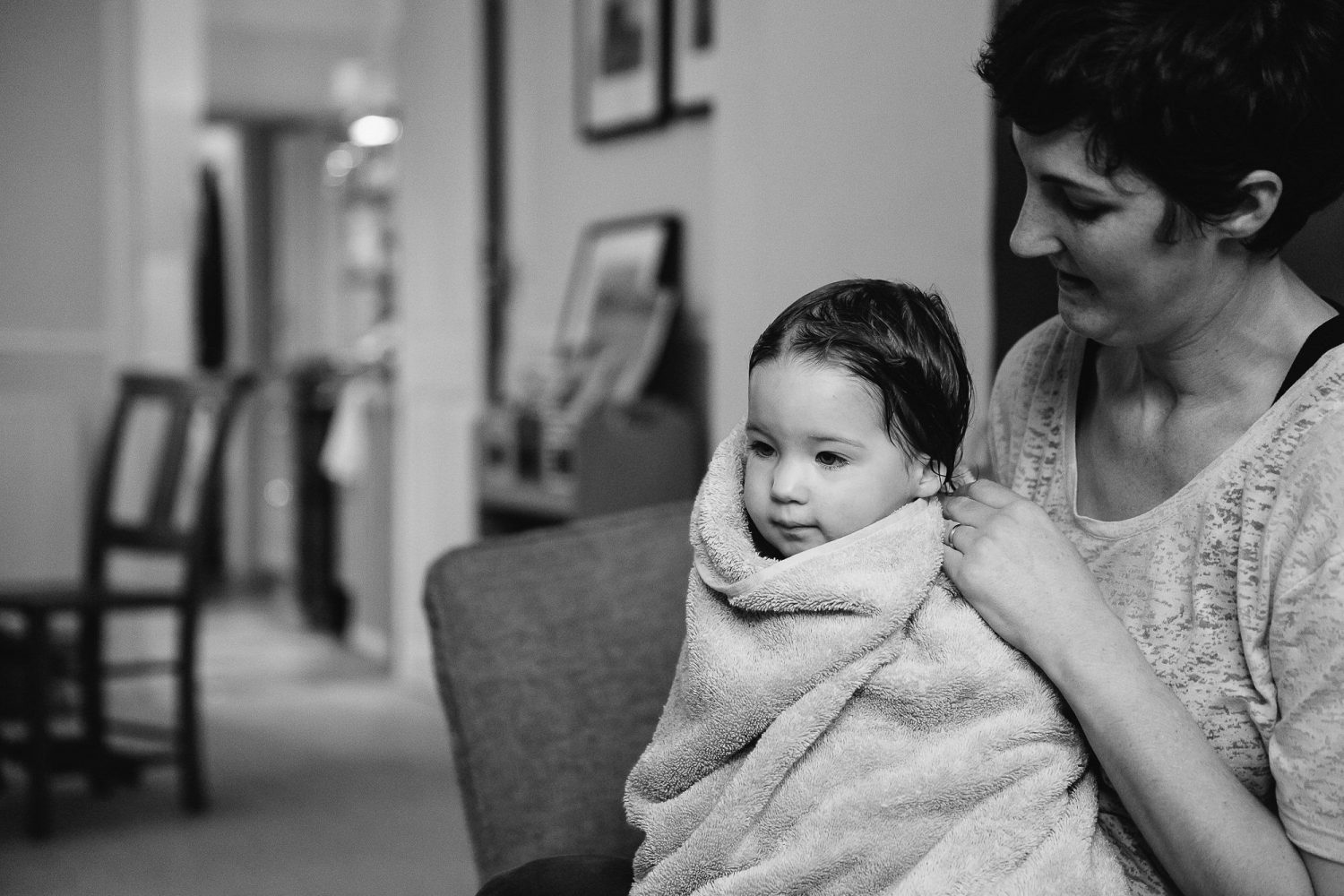 young toddler girl wrapped up in towel with her Mum black and white image