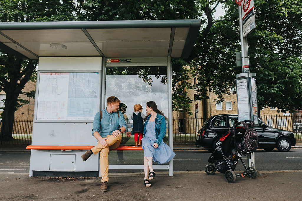 london family photos parents and toddler at bus stop