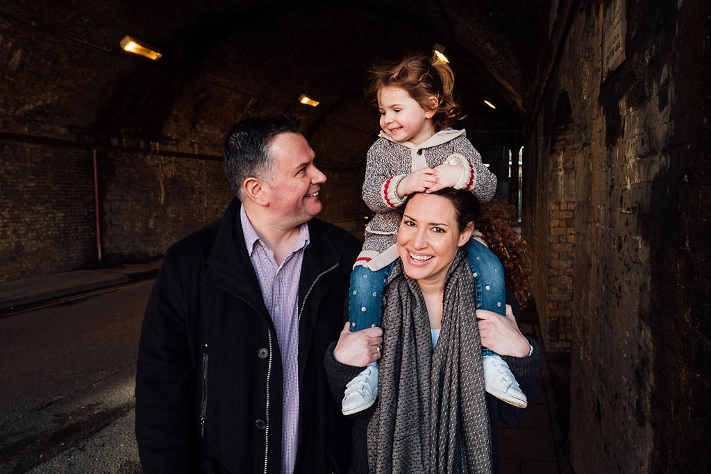 london family with toddler in tunnel