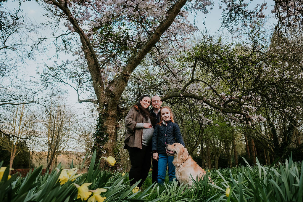 Young family with dog in countryside - maternity shoot Kent