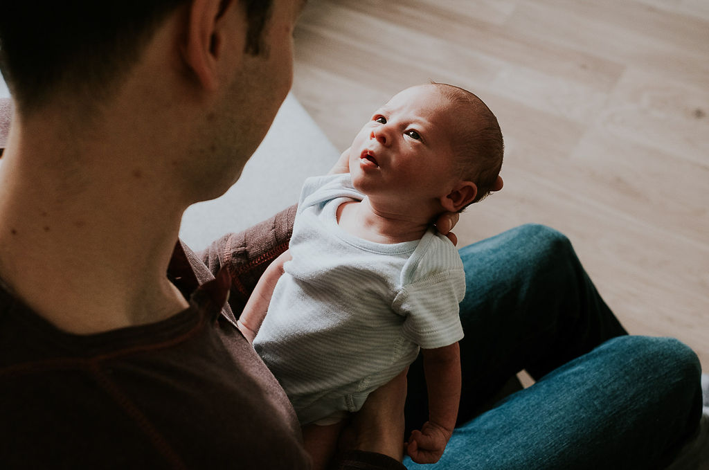 newborn baby looking at parent