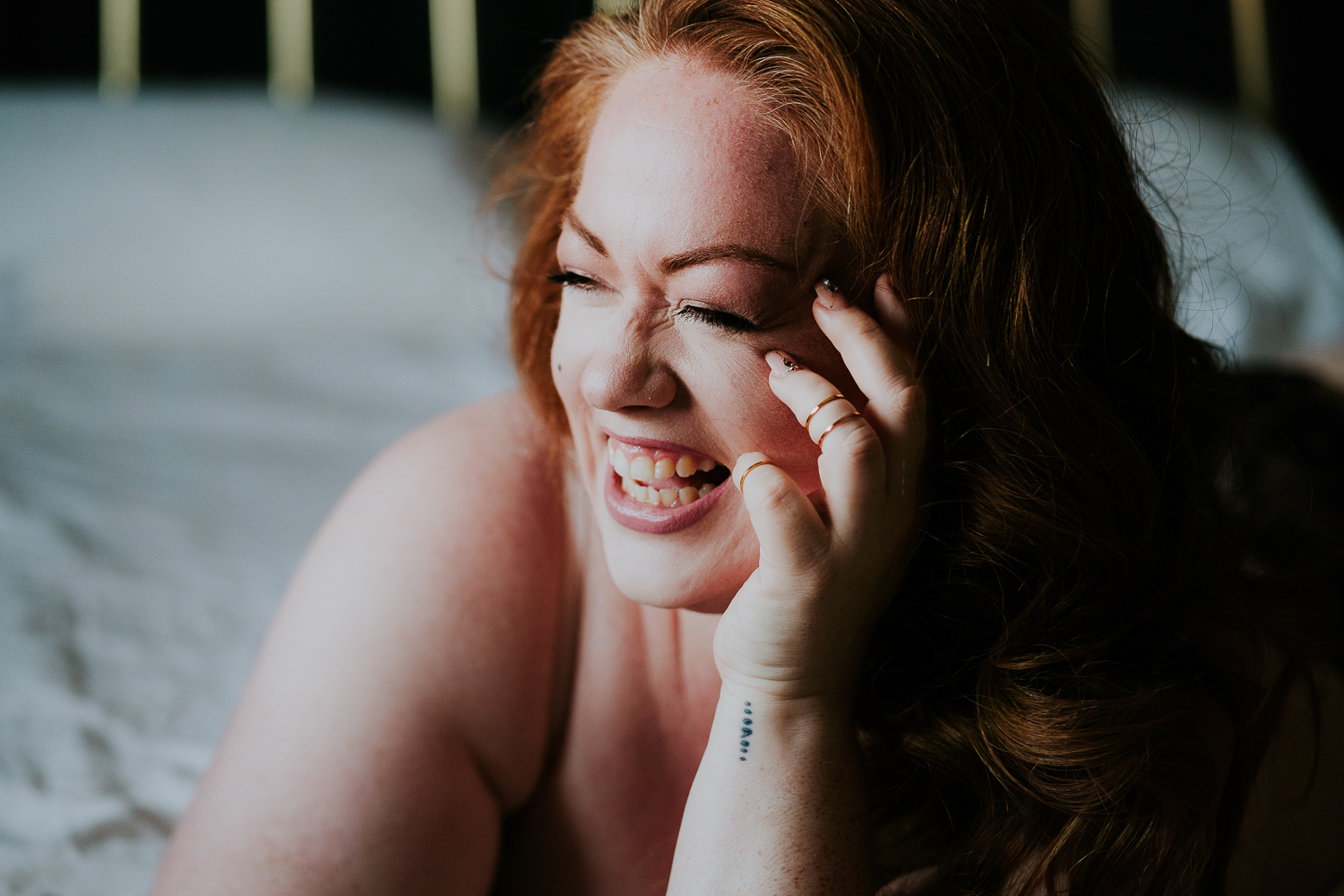 kent boudoir photographer close up laughter redhead woman