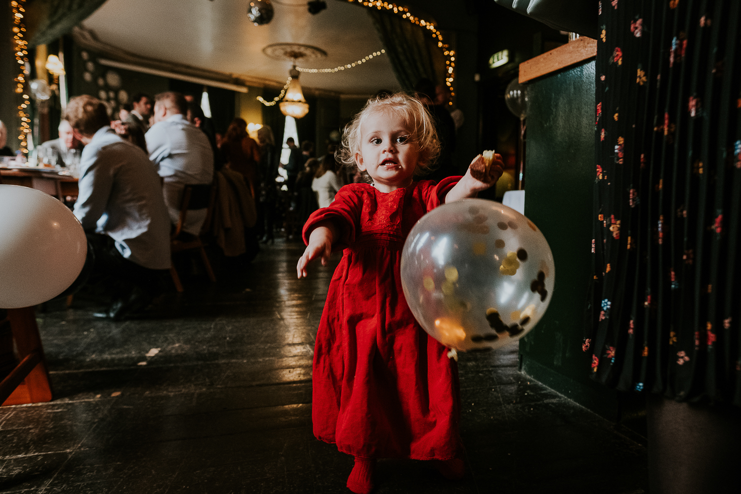 london christening photography toddler girl with giant balloon