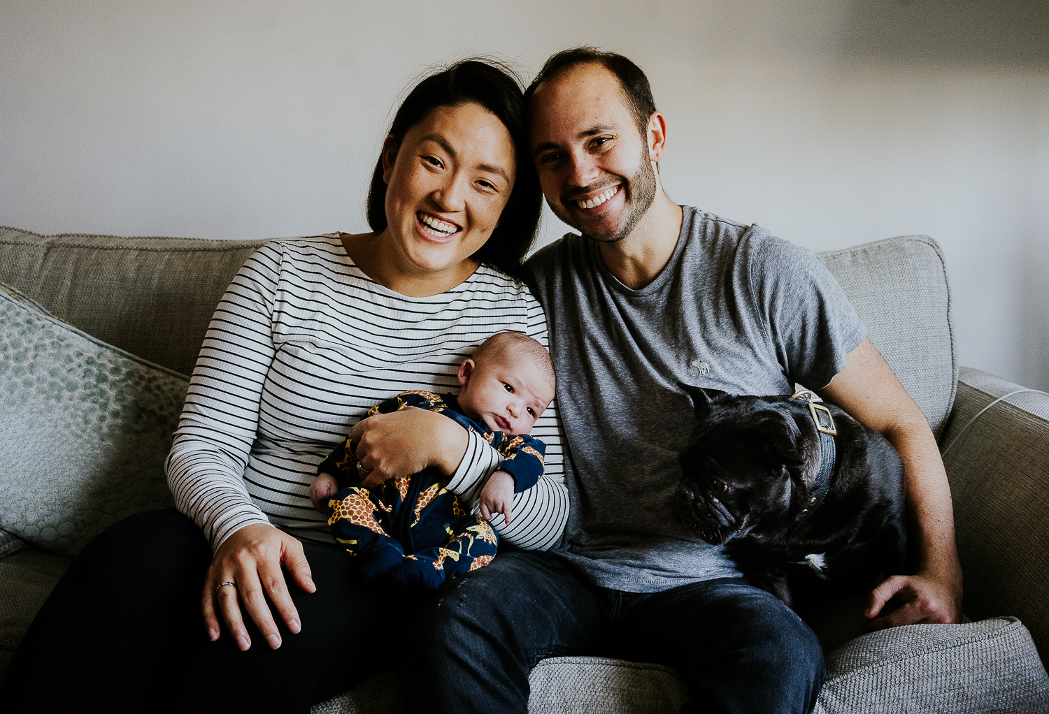 london newborn photo session at home smiling parents with baby