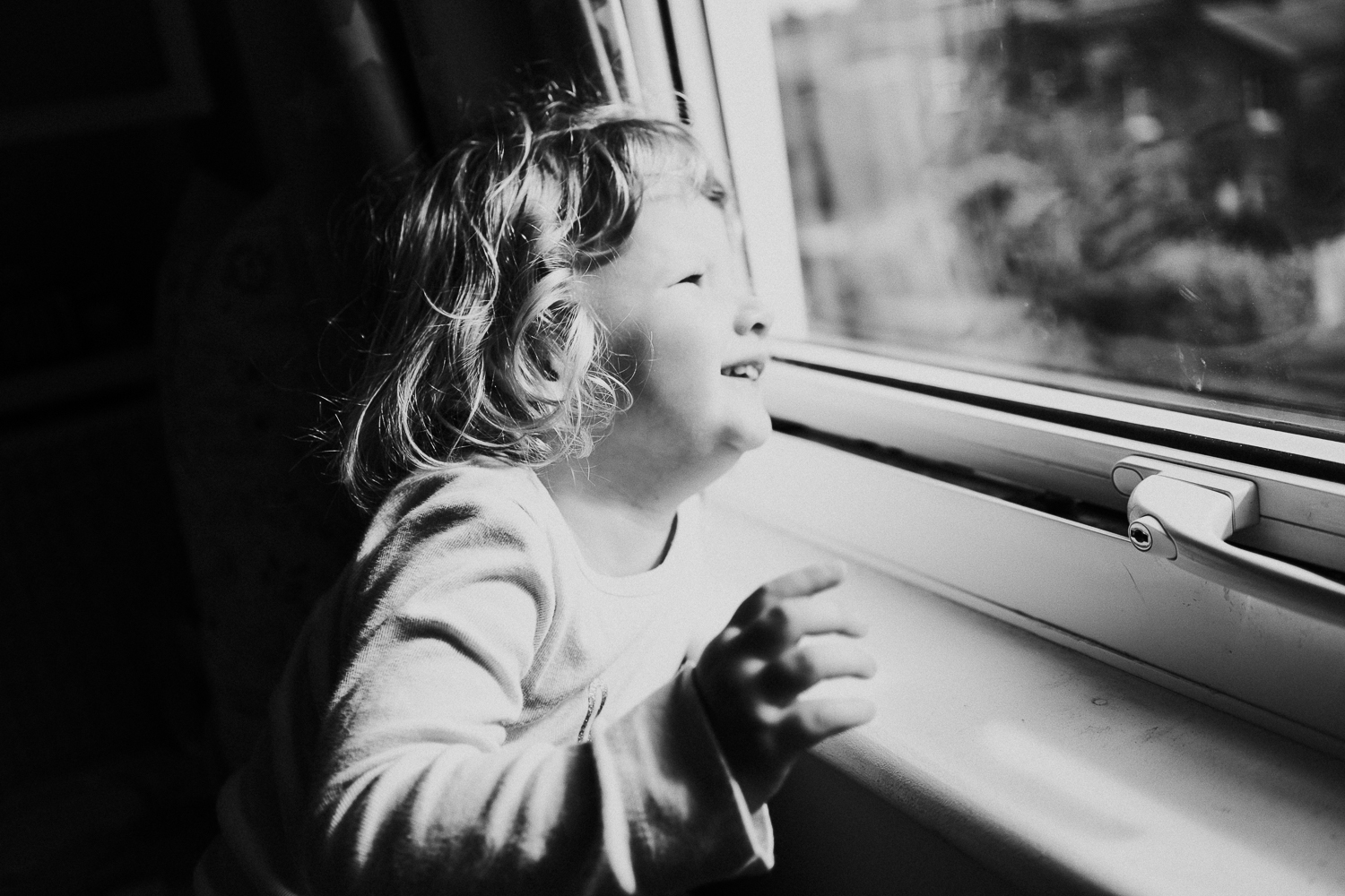 sibling family photography 2020 black and white portrait young girl at window