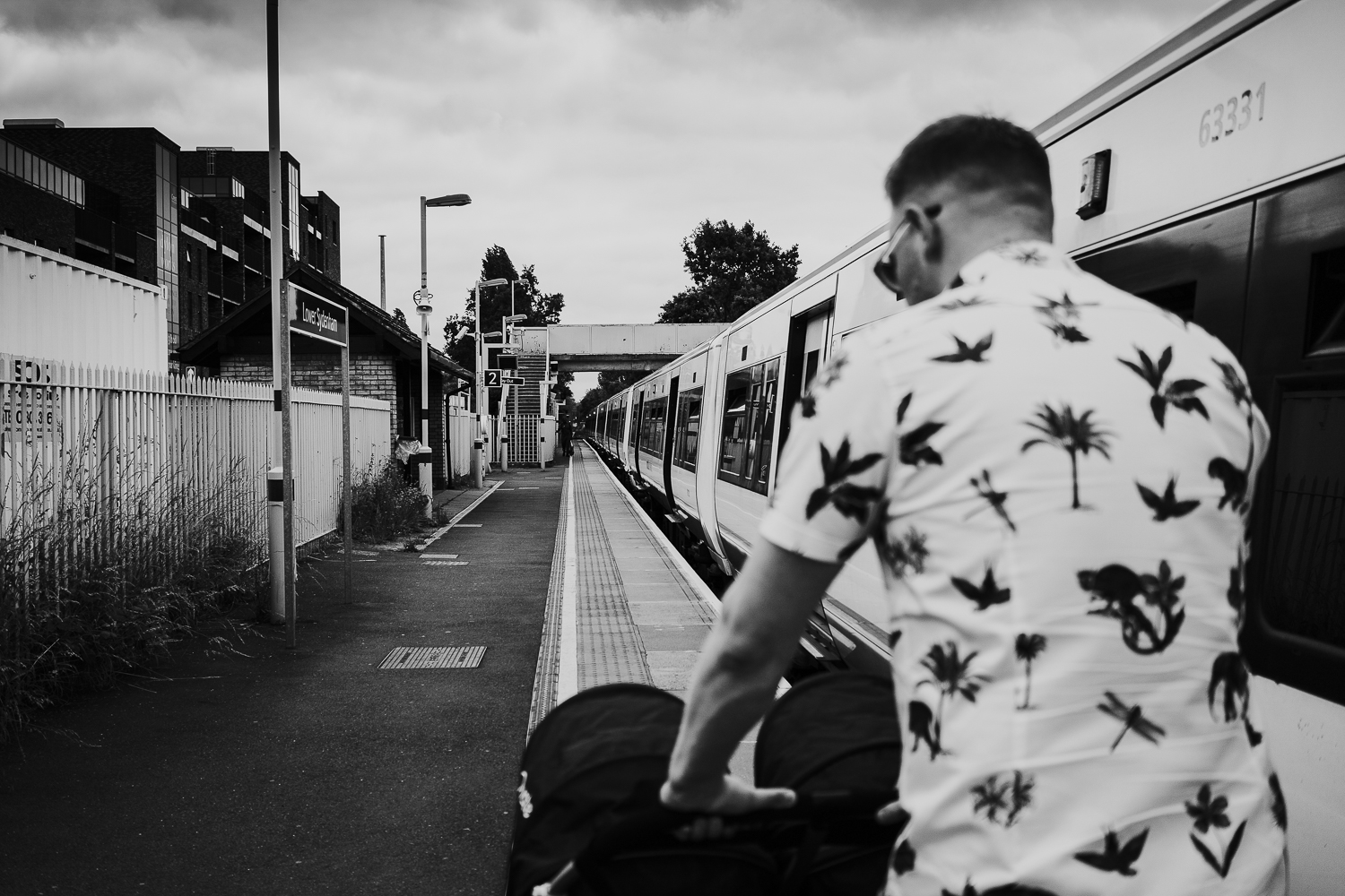 day in the life photo shoot black and white shot of back of man pushing double pushchair