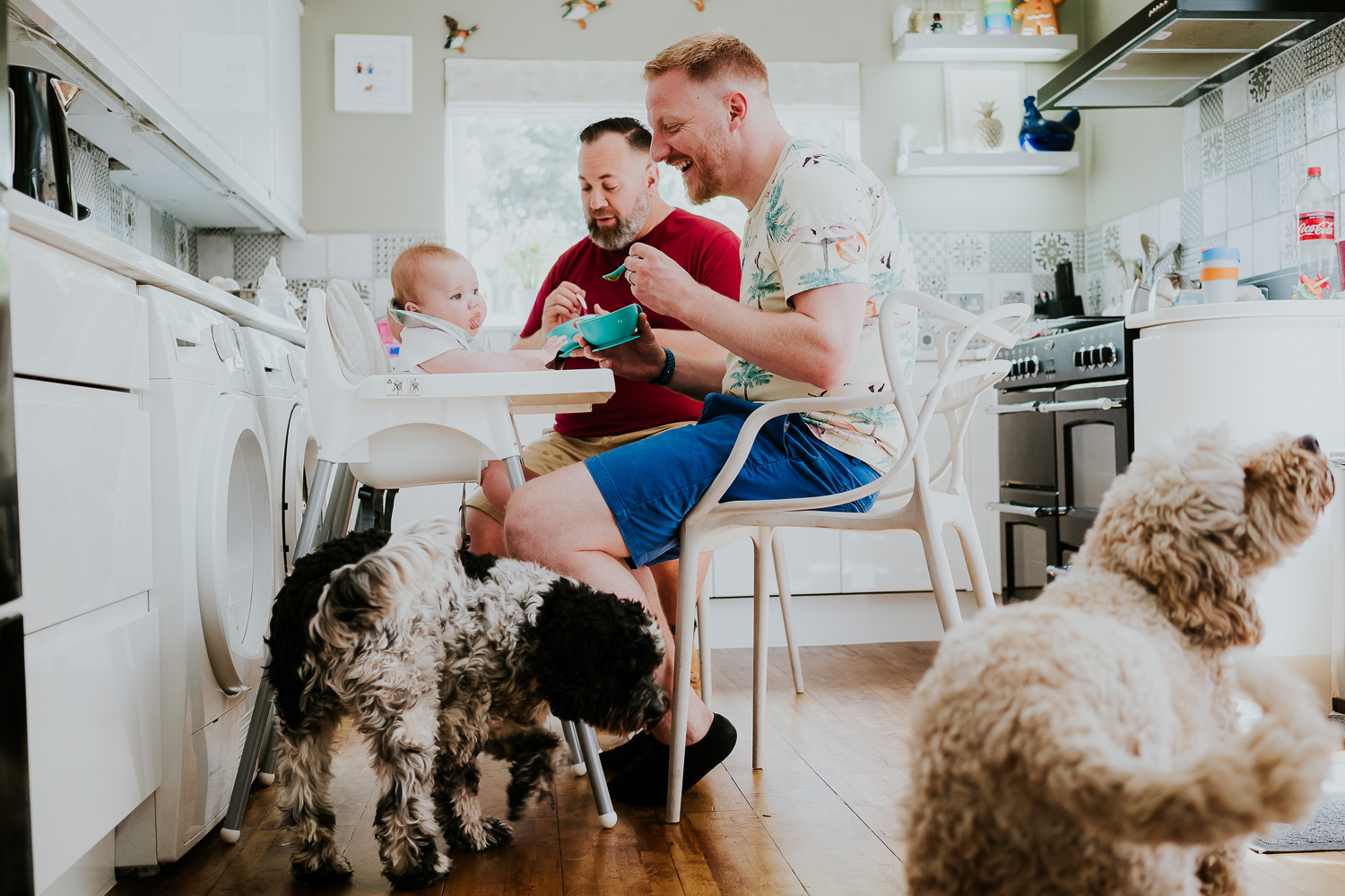 day in the life photo shoot two dads with baby twin girls in kitchen family scene