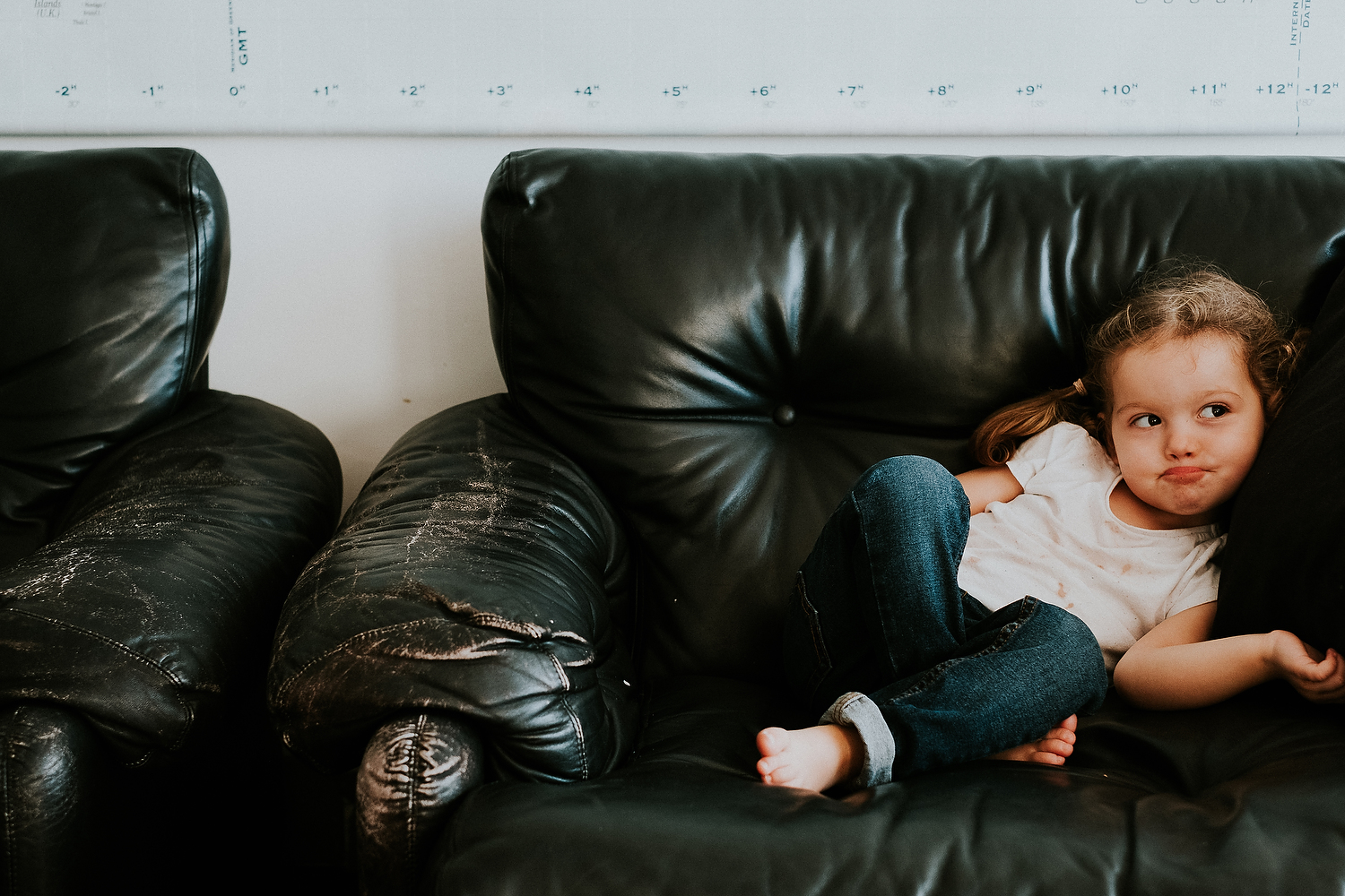 REAL LIFE FAMILY PHOTOS BORED CHILD SITTING ON SOFA