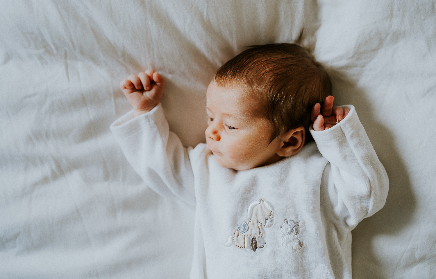 east london newborn photographer baby lying on bed