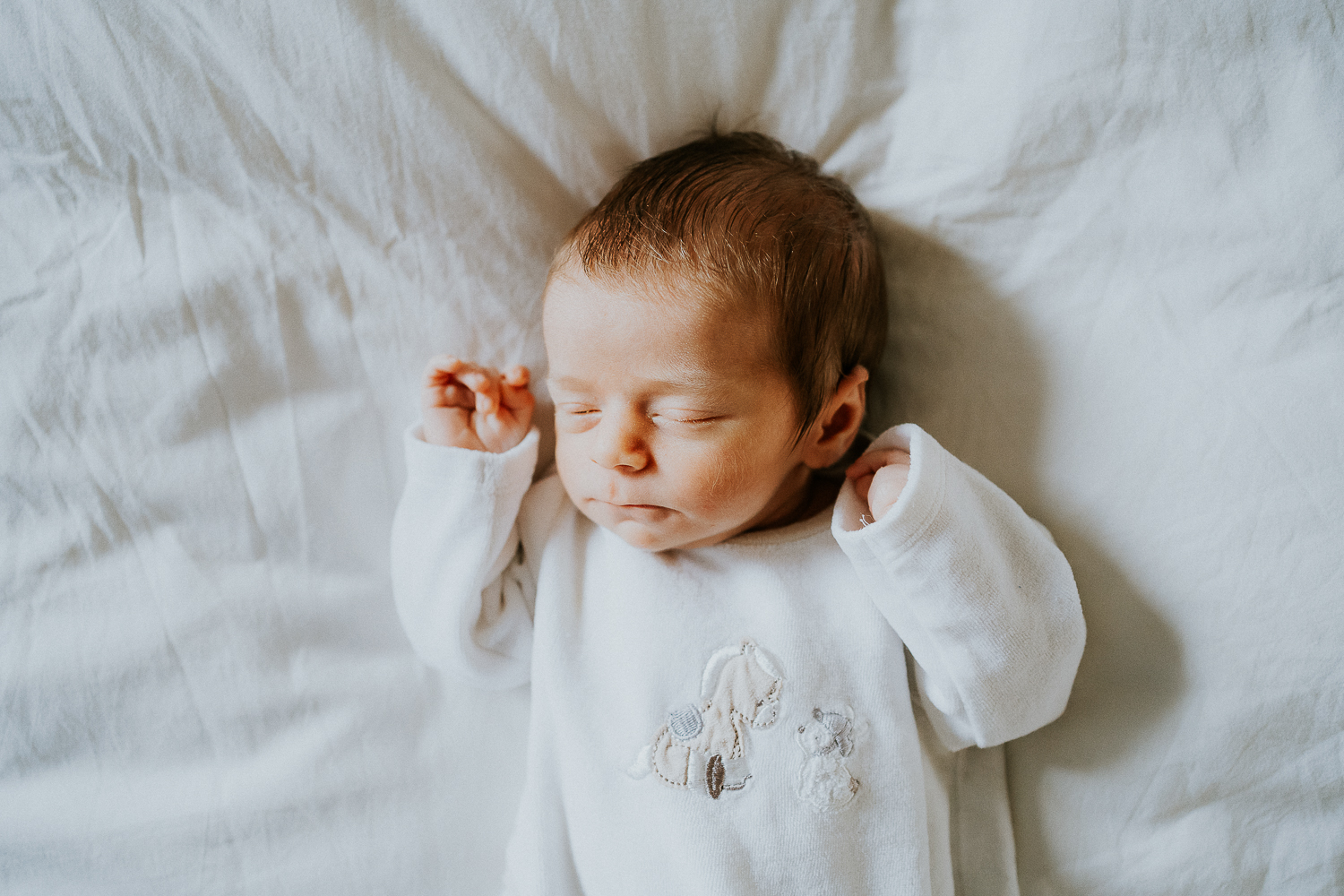 east london newborn photographer baby lying on bed