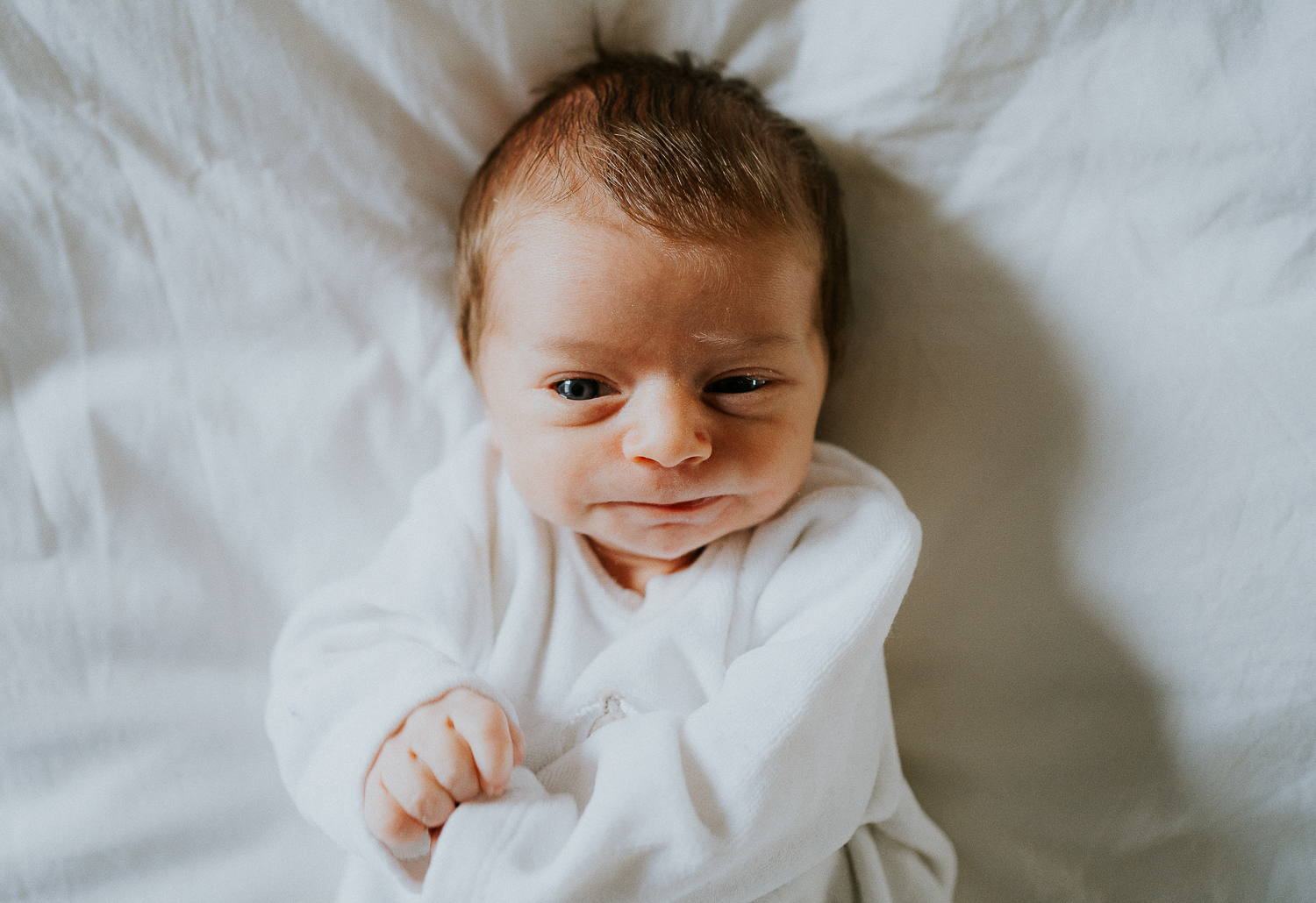 east london newborn photographer baby lying on bed