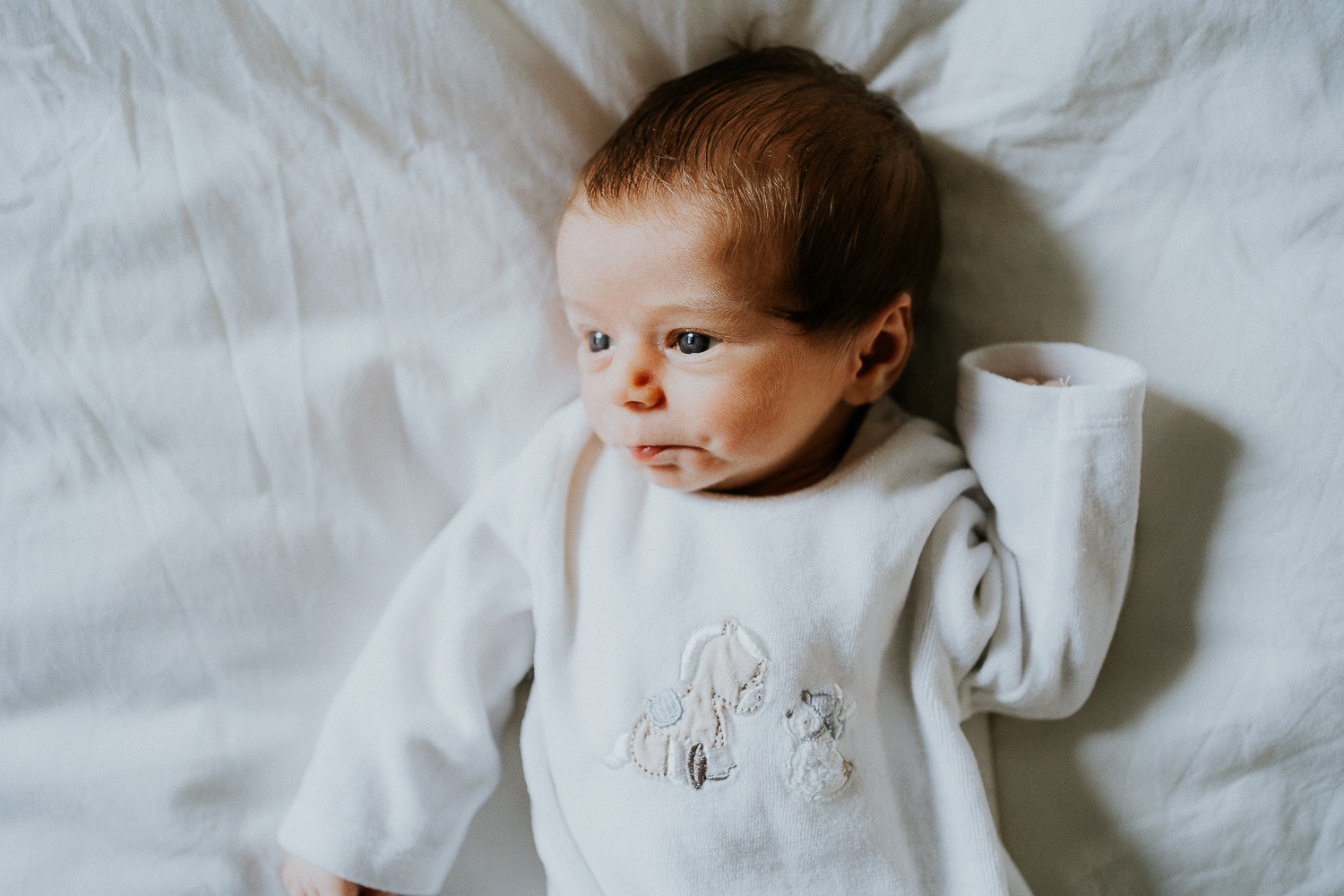 east london newborn photographer baby lying on bed