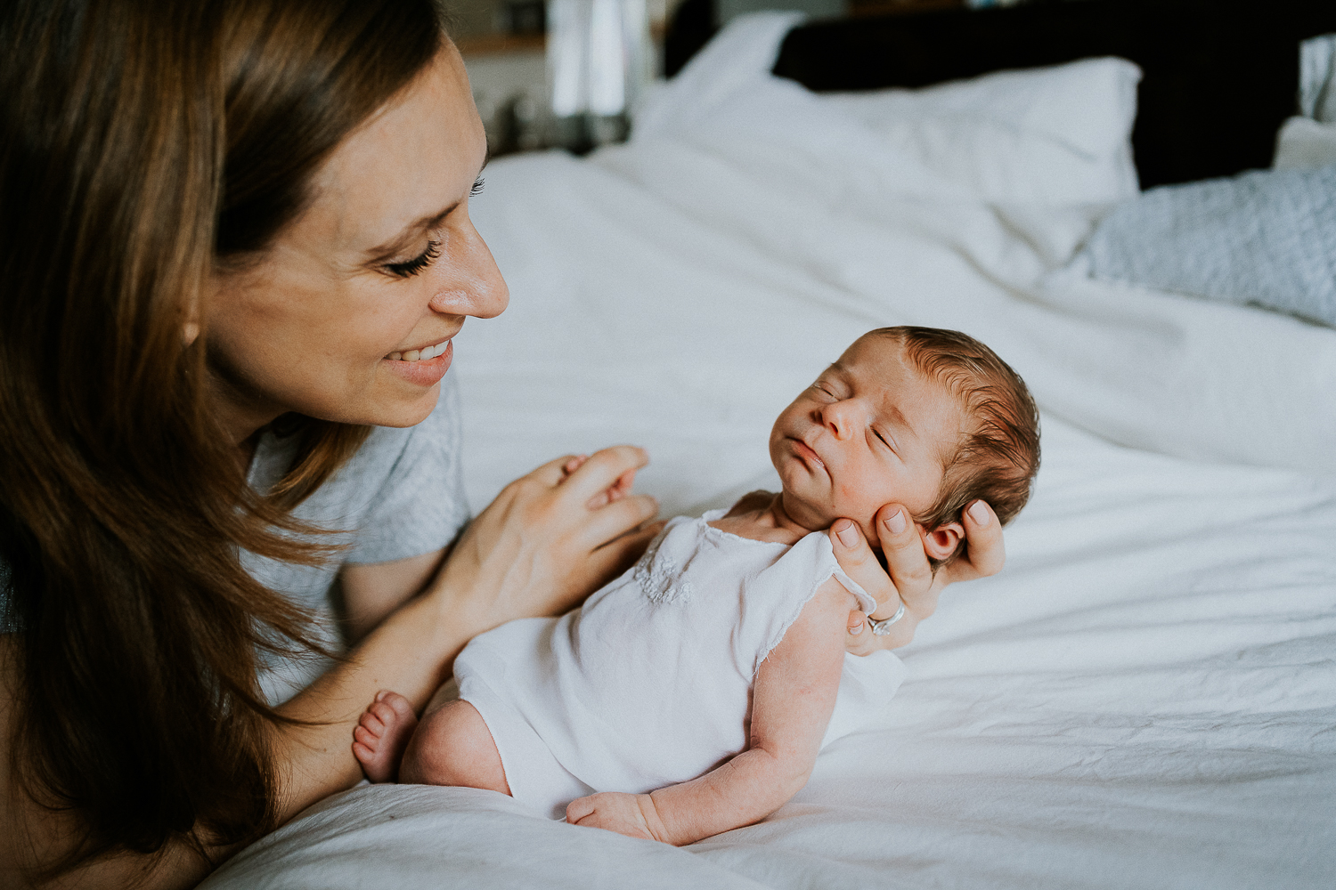 east london newborn photographer mother and baby on bed