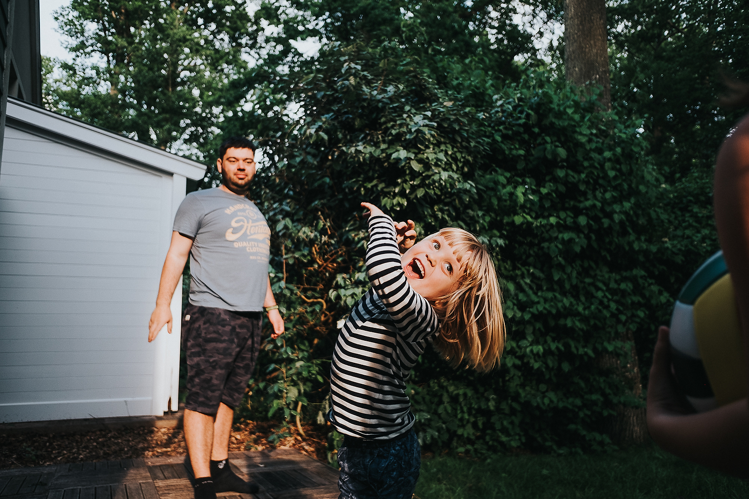 BOY AND FATHER PLAYING WITH FOOTBALL IN GARDEN FAMILY PHOTOGRAPHY AT CENTER PARCS FRANCE LAC D'AILETTE