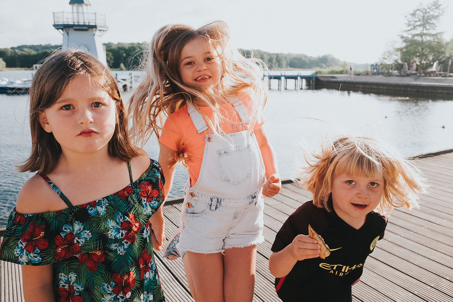 CHILDREN PLAYING BY LAKE ON BOARDWALK FAMILY PHOTOGRAPHY AT CENTER PARCS FRANCE LAC D'AILETTE