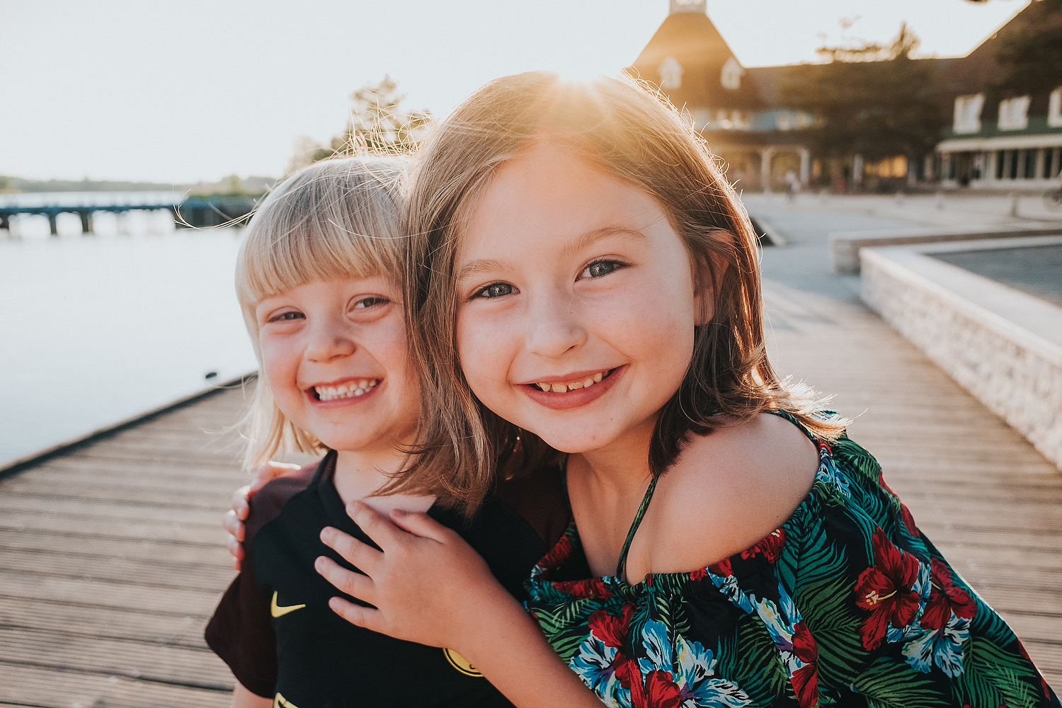 CHILDREN PLAYING BY LAKE ON BOARDWALK FAMILY PHOTOGRAPHY AT CENTER PARCS FRANCE LAC D'AILETTE