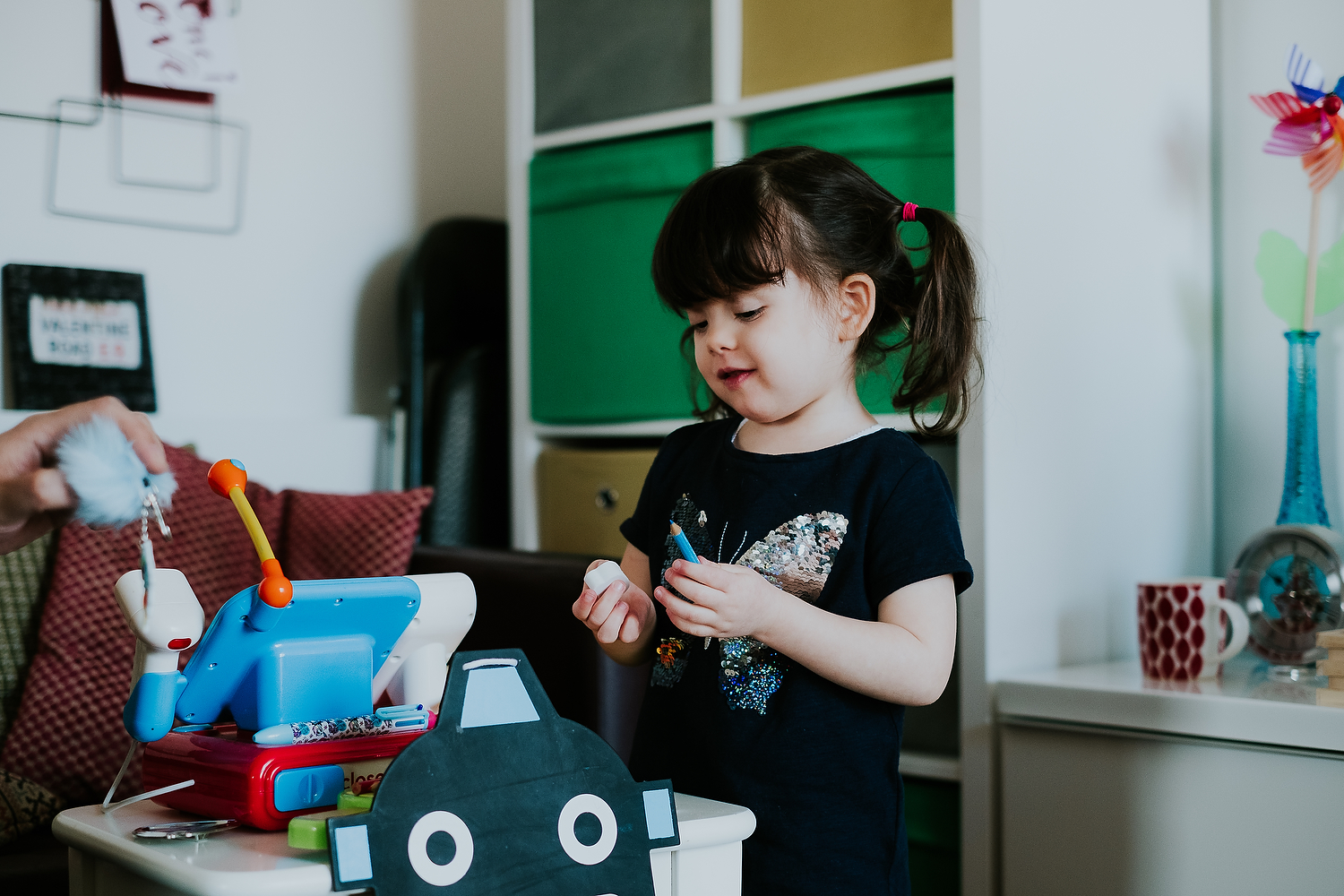 home scene of little girl playing with make believe toys islington family photographer shoot