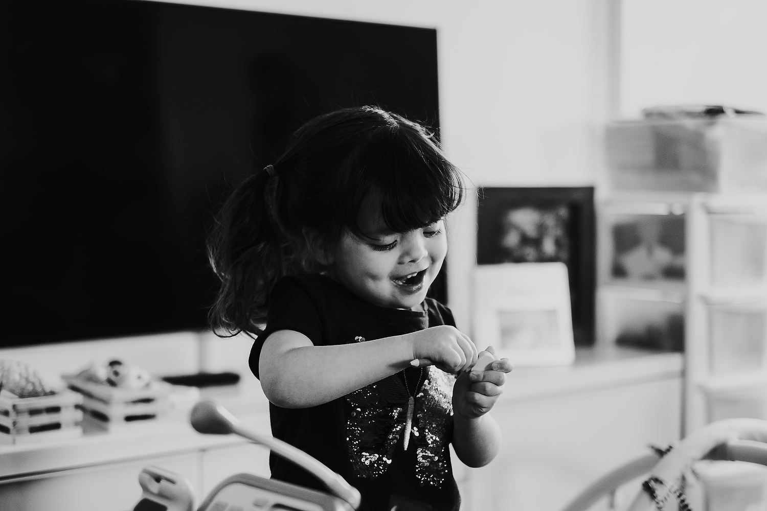 home scene of little girl playing with make believe toys islington family photographer shoot black and white image