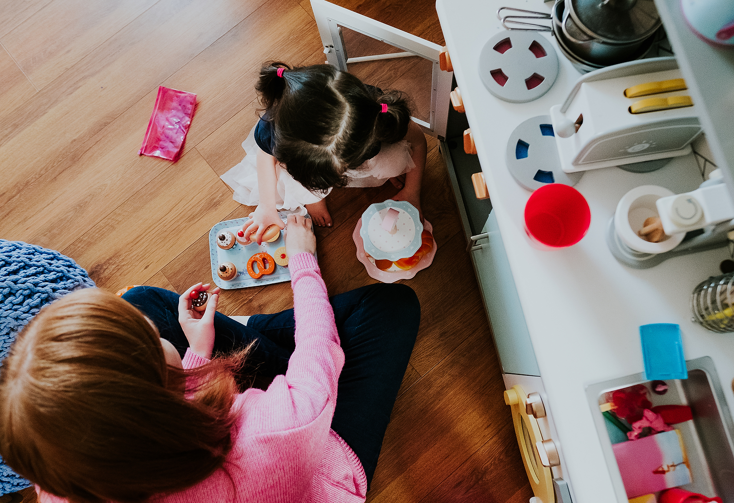 aerial shot of mother and daughter playing make believe with tea set islington family photographer