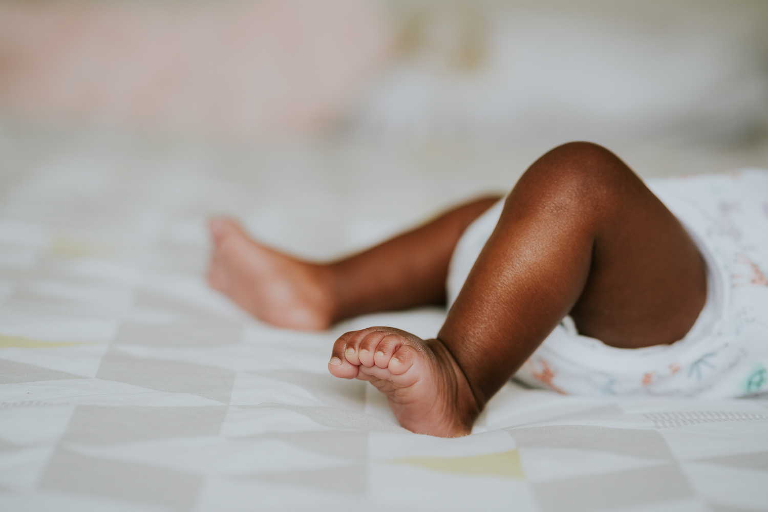 london newborn baby photographer black baby feet on bed person of colour