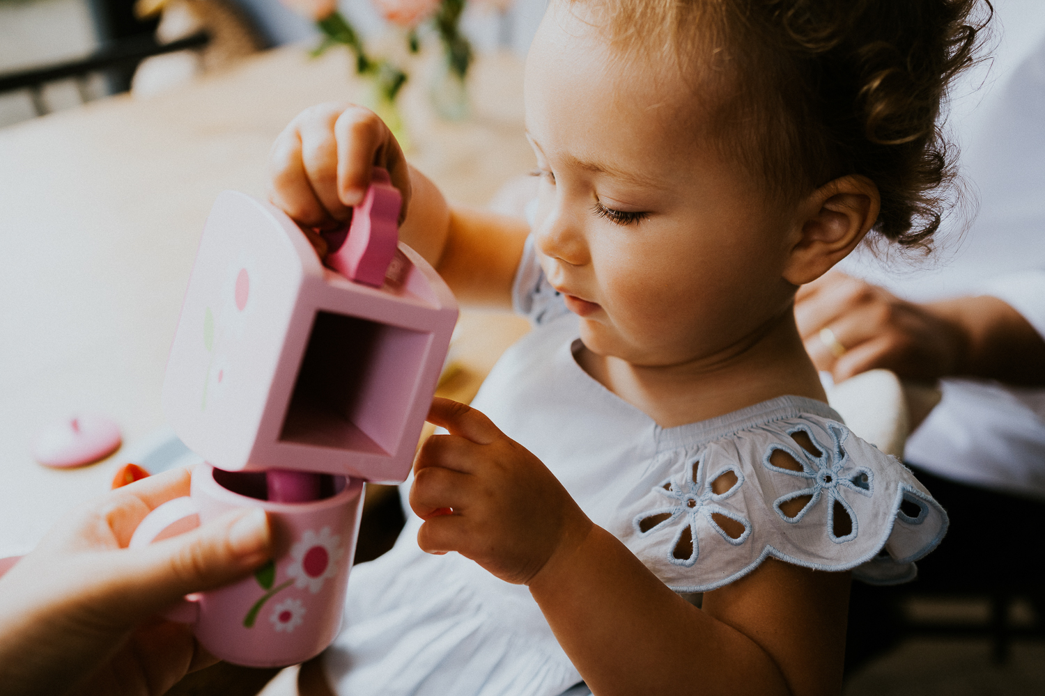 NORTH KENSINGTON FAMILY PHOTO SESSION parents and toddler daughter playing tea time in modern family home