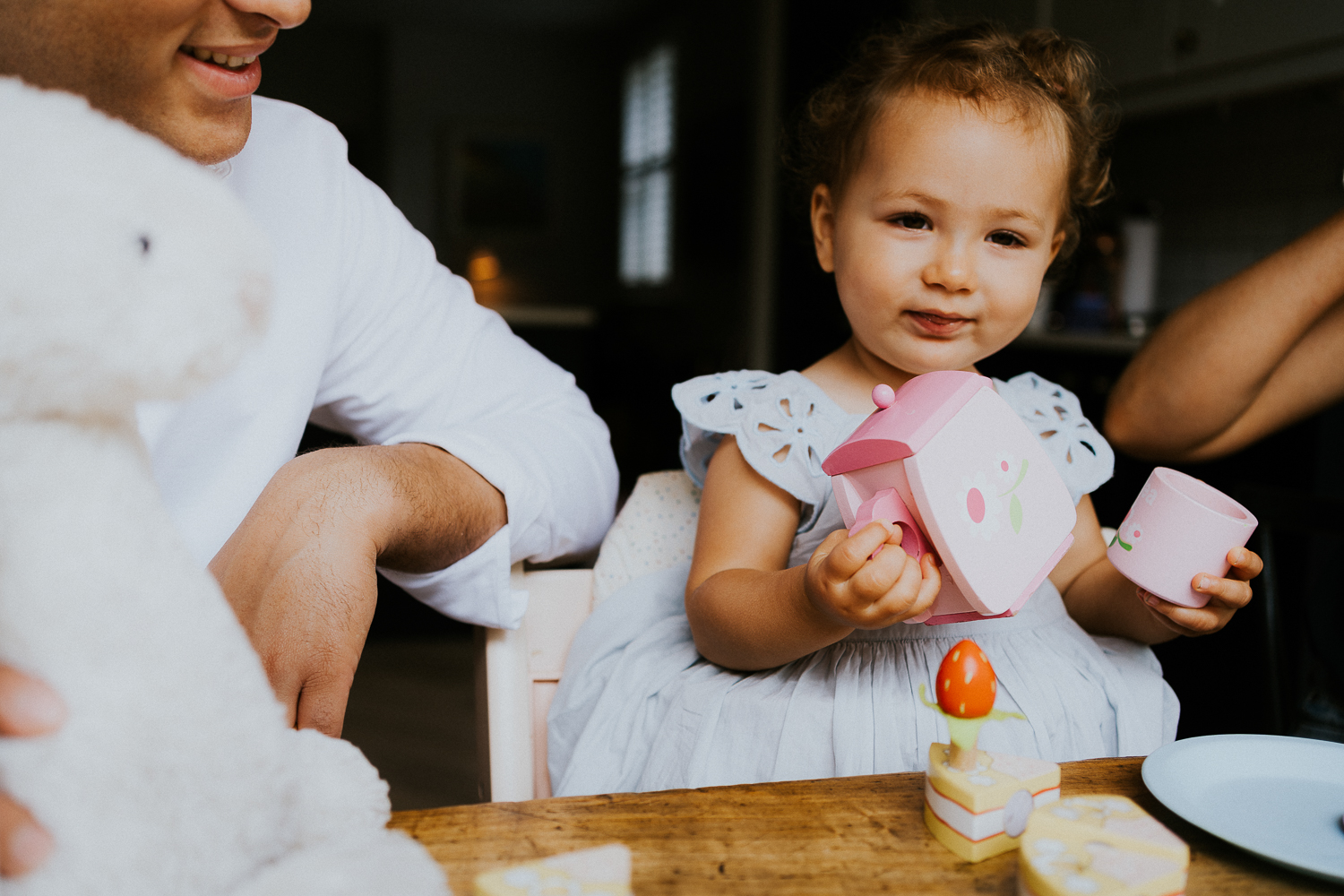 NORTH KENSINGTON FAMILY PHOTO SESSION parents and toddler daughter playing tea time in modern family home
