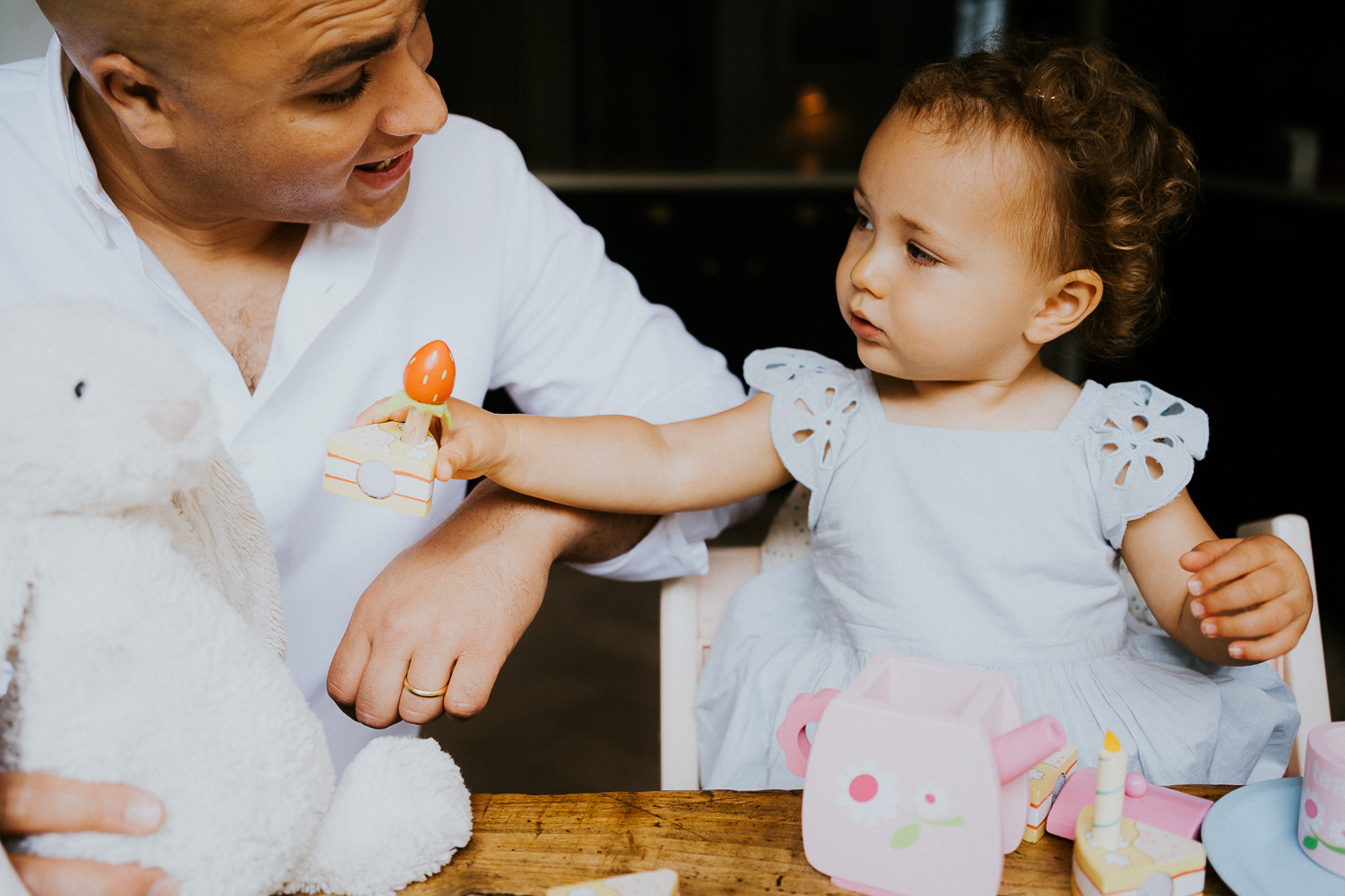 NORTH KENSINGTON FAMILY PHOTO SESSION parents and toddler daughter playing tea time in modern family home