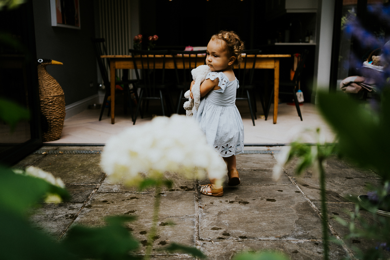 NORTH KENSINGTON FAMILY PHOTO SESSION toddler girl watering flowers in garden at home