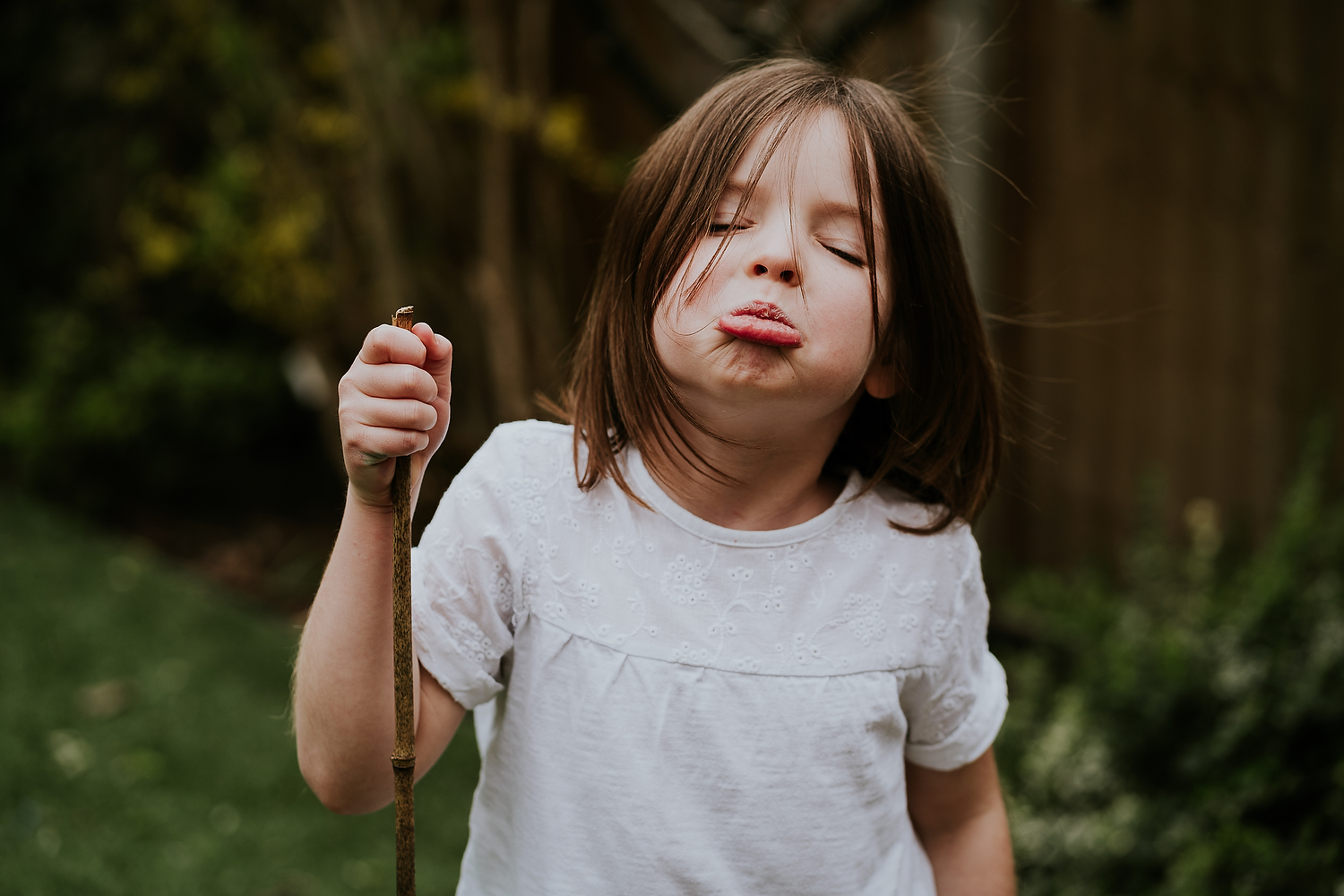 REAL LIFE FAMILY PHOTOS LITTLE GIRL IN GARDEN GRUMPY FACE