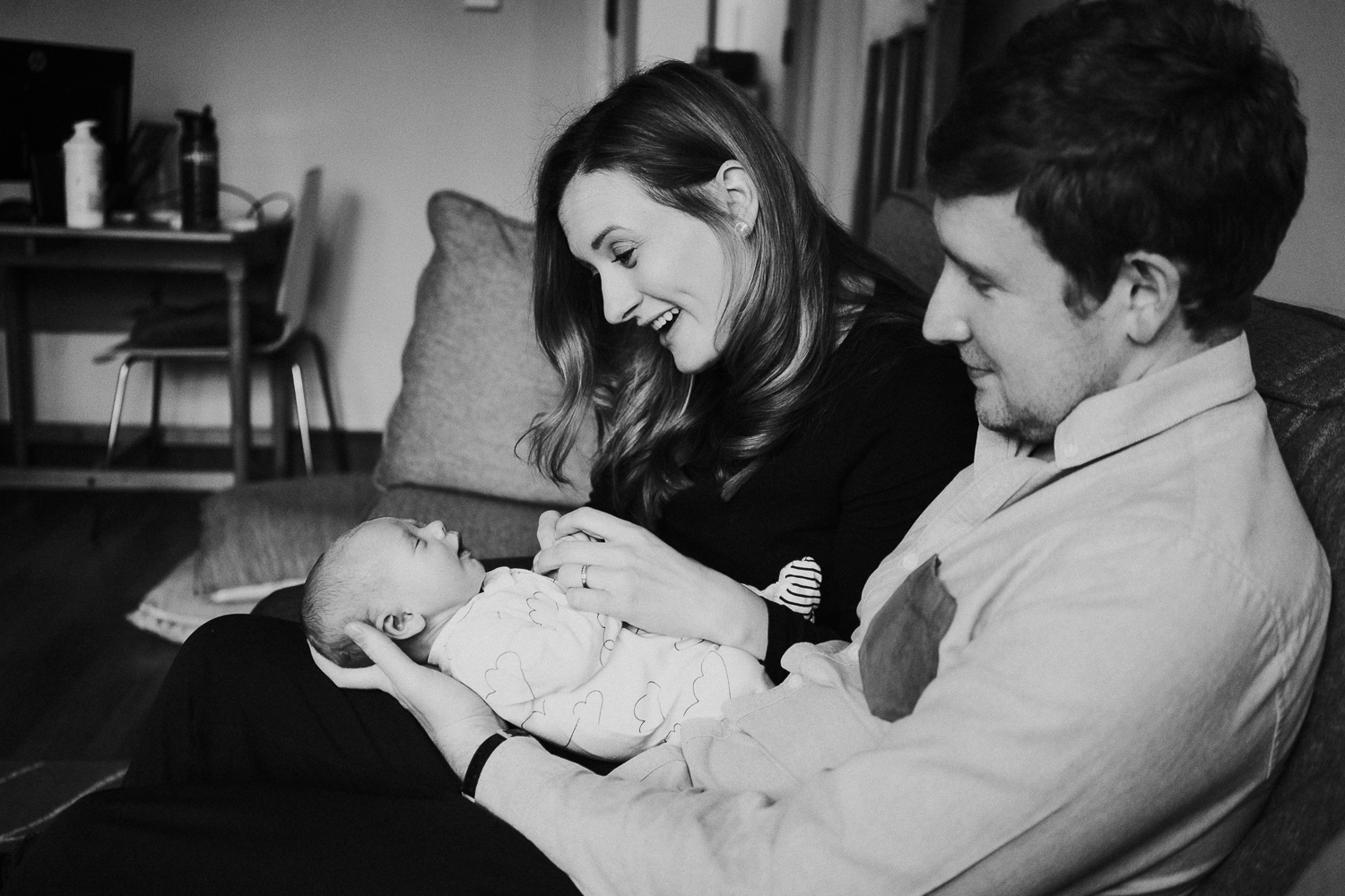 newborn photo session at home in highgate black and white photo of baby boy with parents