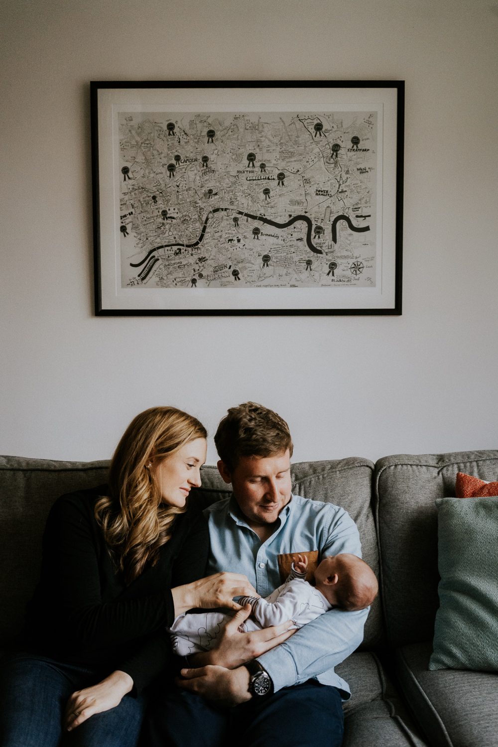 newborn photo session at home in highgate photo of baby boy with mother on sofa