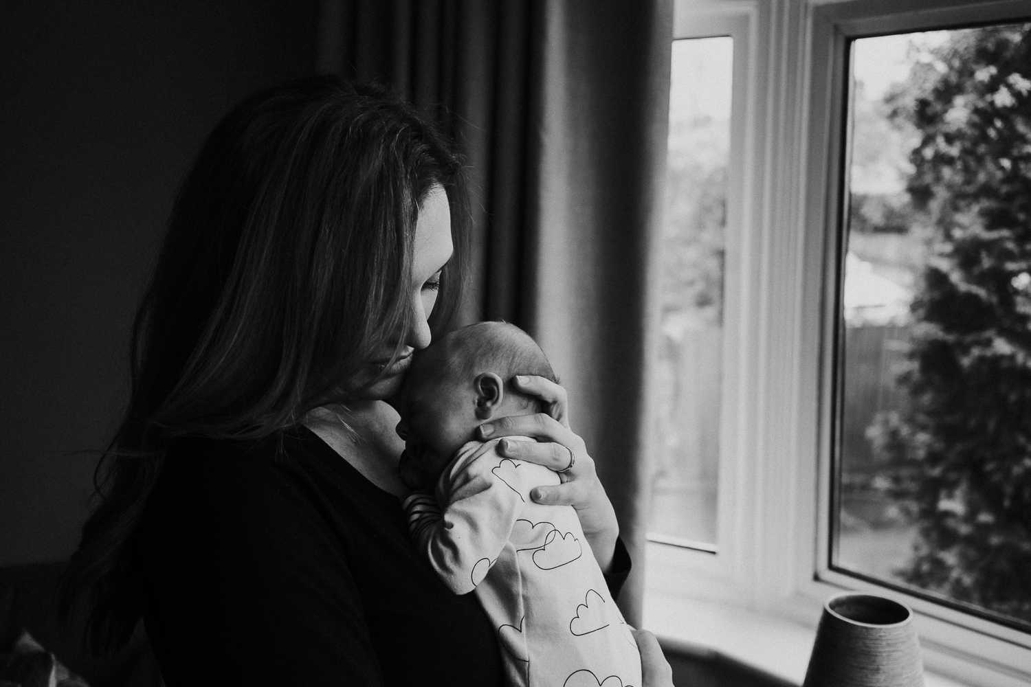 newborn photo session at home in highgate black and white photo of baby boy and mother