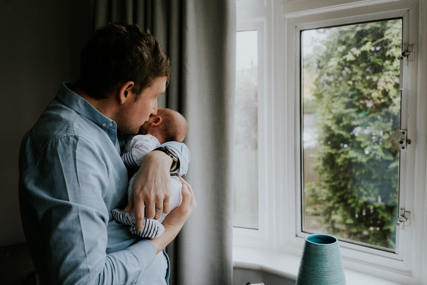 newborn photo session at home in highgate photo of baby boy with father