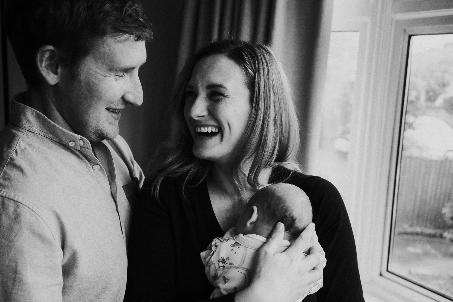 newborn photo session at home in highgate black and white photo of baby boy and parents